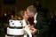 Ashleigh and Chase kiss after cutting the cake.