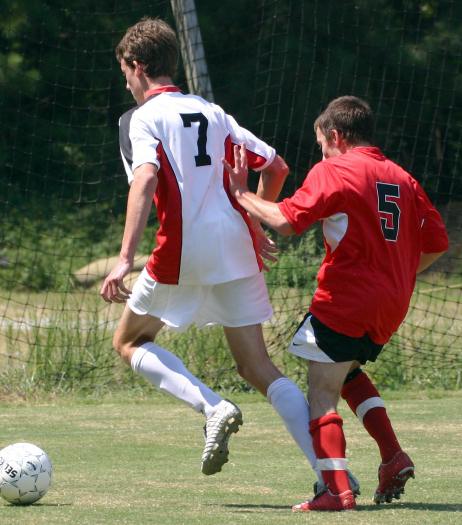 As Morten goes for the ball, #5 gives him a hand