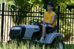 John cuts the tall grass with the newly-repaired mower