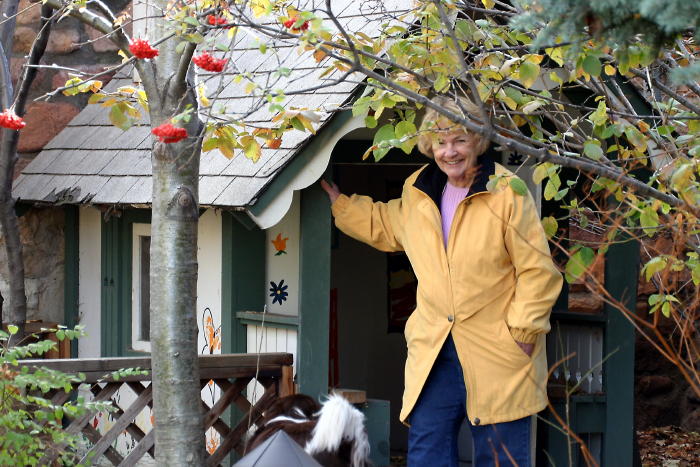 Nana poses in front of the playhouse